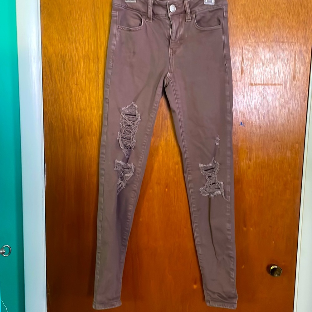 American eagles jeans size 0. Color a lighter purple or mauve.